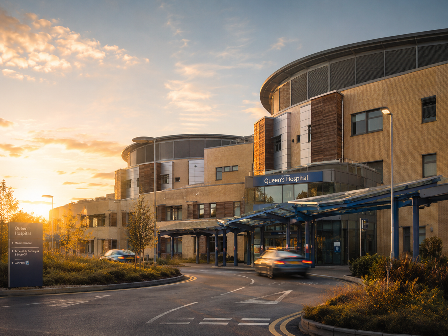 Queen's Hospital main entrance at sunset